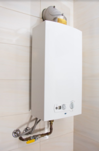 White tankless water heater installed on a white wall.